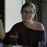 Carla Brogan Young woman with dark hair and glasses